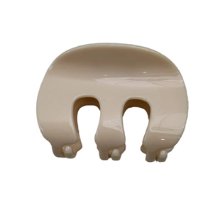 Minimalist beige M-shaped medium hair claw clip with smooth glossy finish for women