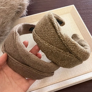 Wide woolen headbands in brown herringbone and beige texture for autumn and winter fashion