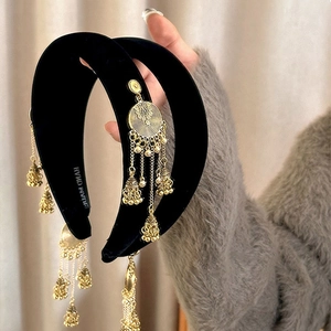 Detail of velvet headband with golden metallic tassels and ethnic jhumka bells