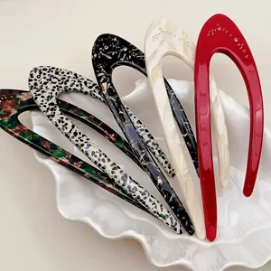 U-shaped hair pins in tortoise, marble, and leopard patterns with crystal accents