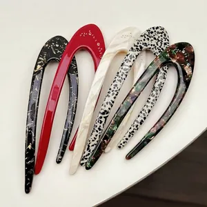 U-shaped hair pin set with acetate marble patterns and rhinestone accents