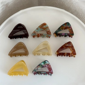 Set of eight French-style acetate triangle hair claws with elegant marble and amber patterns