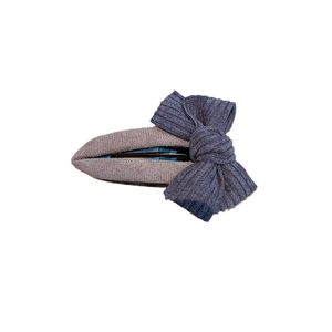 Elegant deep purple fabric bow hair clip with textured ribbon on a clean white background