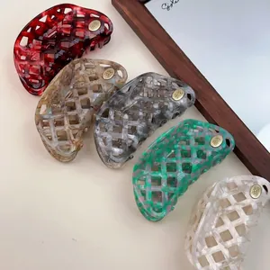 Five-piece hollow grid acetate hair claw set in tortoiseshell colors with gold logo
