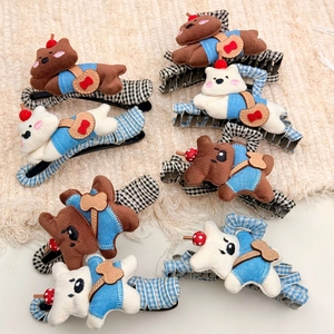 Detail showing plush teddy bear hair clips with plaid fabric base and cute outfits