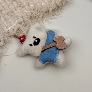 Detailed view of a handmade fabric bear hair clip with denim shirt and red polka dot detail