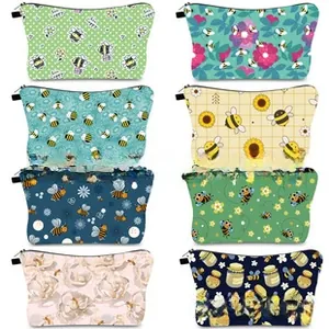 Multiple digital print cosmetic bags featuring cartoon patterns and secure black zipper closures