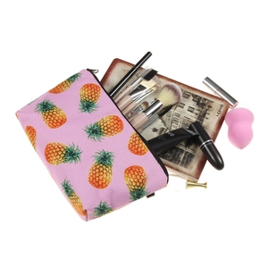 Pink pineapple print cosmetic bag showing internal storage for makeup brushes and tools