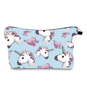 Detail view of the smooth black zipper and unicorn print on the blue makeup bag