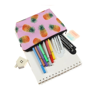 Pink canvas pineapple print makeup and stationery pouch with a black zipper closure