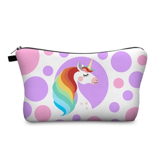 Detail of unicorn digital print and polka dots on white fabric makeup pouch with black zipper