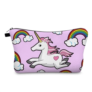 Detail of pink unicorn print makeup bag with rainbow patterns and black zipper closure