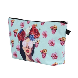Detail view of floral girl print makeup bag with mint green background and pink roses