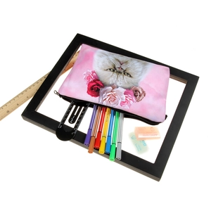 3D cat print cosmetic bag with floral design used as a pink stationary pencil case