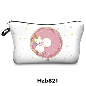 Close-up of unicorn and donut printed white makeup bag with a black zipper and side strap