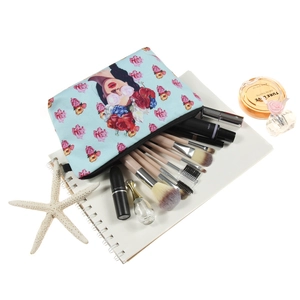 Floral print makeup bag for women with zippers and cosmetic brushes on white desk