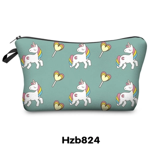Close-up of mint green makeup bag with unicorn prints and black zipper detail