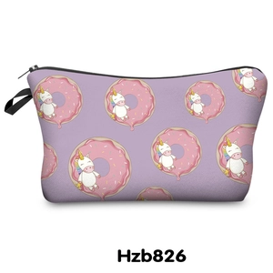 Detail of purple unicorn cosmetic bag featuring a donut print and black handle