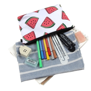 Watermelon print makeup bag with zipper and stationery set on a bright desk background