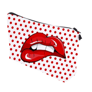 Detail view of the zipper pouch showing red polka dots and lip print design
