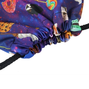 Detail of drawstring backpack featuring cat and donut digital prints on purple galaxy fabric