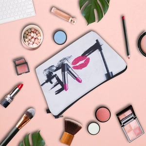 Multipurpose Love printed makeup bag for women surrounded by various beauty cosmetics
