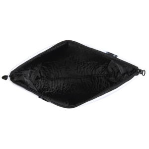 Detail shot showing the spacious black interior lining and geometric patterns of the cosmetic bag