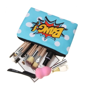 Pop art style Bang printed cosmetic bag with blue polka dots and makeup accessories