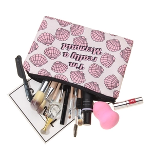 Pink mermaid shell print makeup bag with 'I'm really a Mermaid' text and accessories