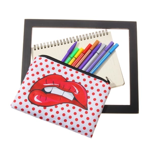 Cosmetic bag with red lip and polka dot pattern featuring a black zipper top