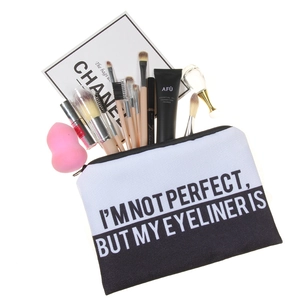 Detail of unicorn print makeup bag interior showing various cosmetic storage tools