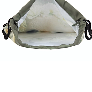 Olive green drawstring backpack with white floral print interior lining and black cords