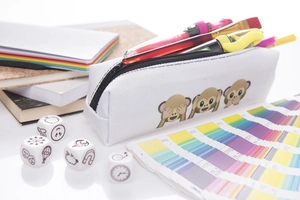 Detailed view of white canvas pencil case with 3D monkey prints and colored pens