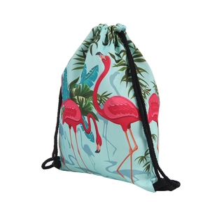Detail of pink flamingo and tropical palm leaf print on light blue drawstring bag fabric