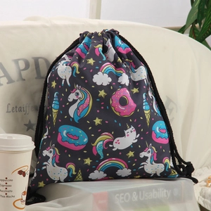 Detail of canvas drawstring bag featuring colorful unicorn and rainbow print on black fabric