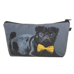 Close-up of the cute black pug dog print and yellow bow tie on the canvas makeup bag