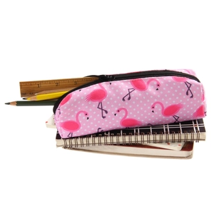 Detail of pink flamingo print canvas makeup bag with black zipper and white polka dots