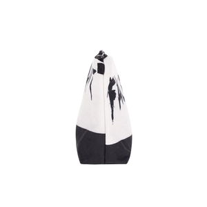Side view of canvas makeup bag with black and white artistic ink splash pattern