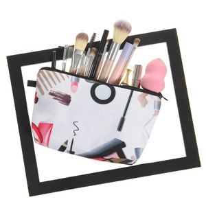 Cosmetic bag detail showing makeup brushes and beauty blender stored inside the pouch