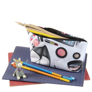 Cosmetic print canvas makeup bag and stationery pouch on a desk with notebooks