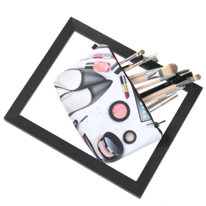Cosmetic bag with high heel prints featuring interior makeup brushes and smooth zipper