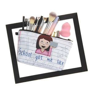 Detail shot of canvas makeup bag showing interior with brushes and school theme print