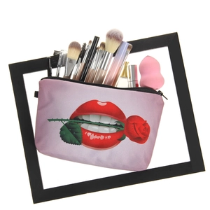 Lavender makeup bag with red lips and rose print featuring brushes and sponge