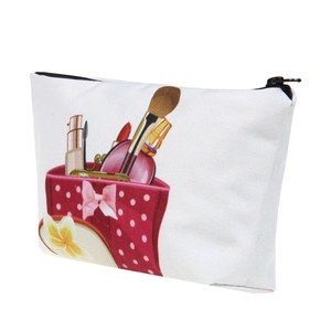 Detail view of a white canvas cosmetic bag featuring vibrant makeup themed floral printing