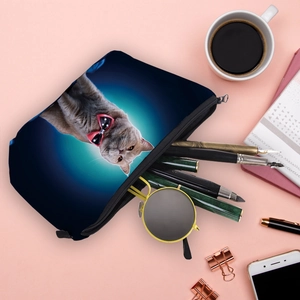Blue makeup bag with British Shorthair cat print featuring office supplies flat lay view