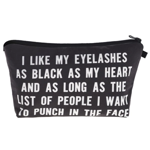 Detail view of black canvas makeup bag with white funny eyelash quote and zip closure
