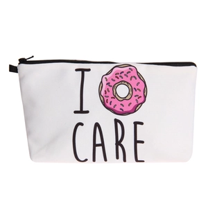 Detail of canvas makeup bag with I Care donut print and black top zipper closure