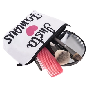 White canvas makeup bag with Insta Famous print and pink heart showing storage capacity