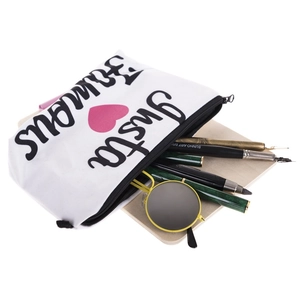 White Insta Famous canvas makeup bag with pink heart, containing pens and sunglasses