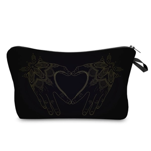 Detail of black makeup bag showing golden mandala hand heart print and smooth zipper closure